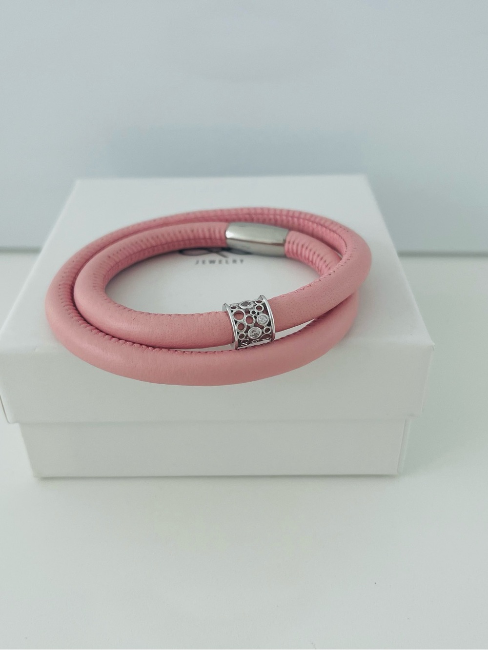 Pink double leather bracelet with silver modern charm.